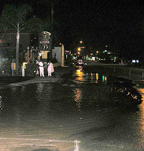 Broken water main hinders repair of cut phone cables